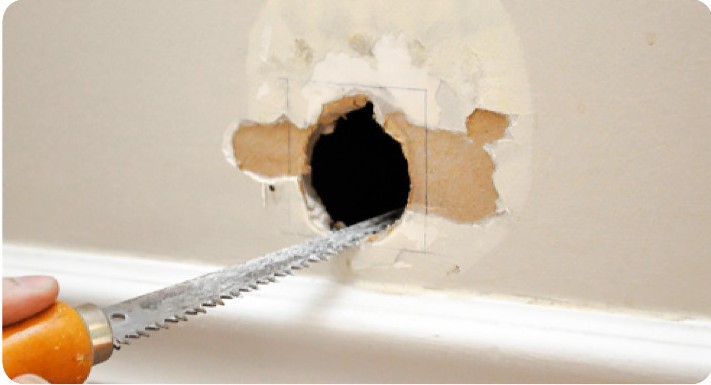 Small hole in drywall before repair