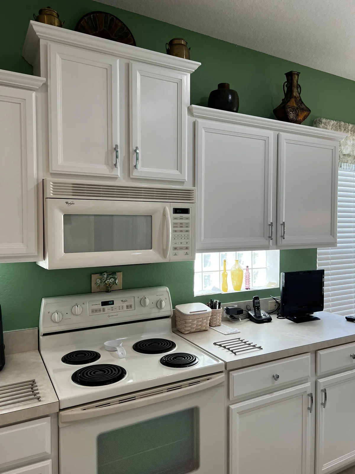 White painted kitchen cabinets after refinishing