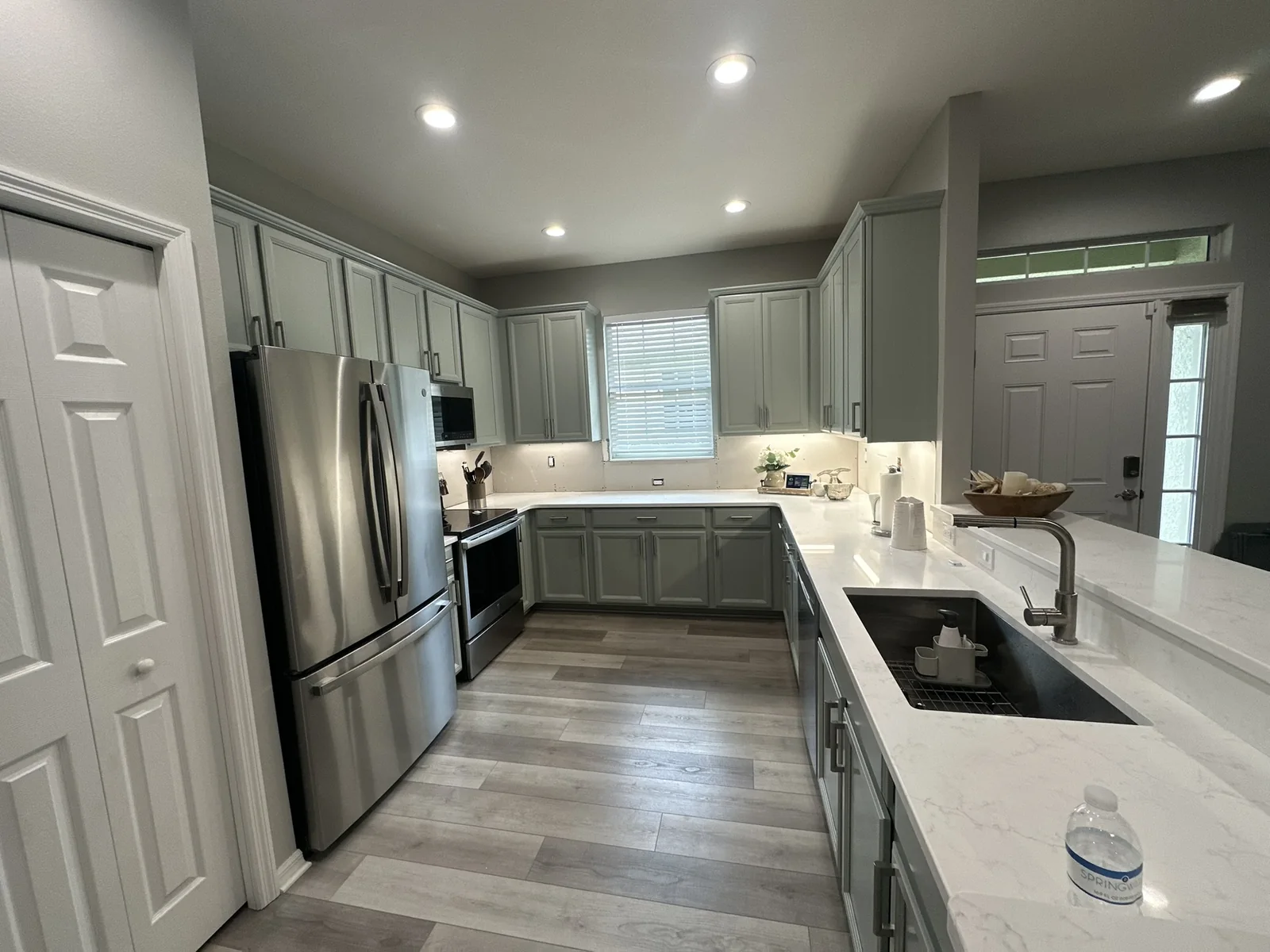 Gray painted kitchen cabinets after refinishing